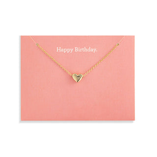 Gold heart necklace on a pink card with 'Happy Birthday' text