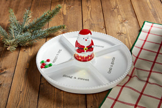 A ceramic singing light-up Santa sitter