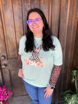 Leopard Floral Bunny Mint Tee - Your perfect new tee for Easter. This graphic tee provides a retail unisex fit. It boasts a striking graphic print that enhances the character of any outfit.