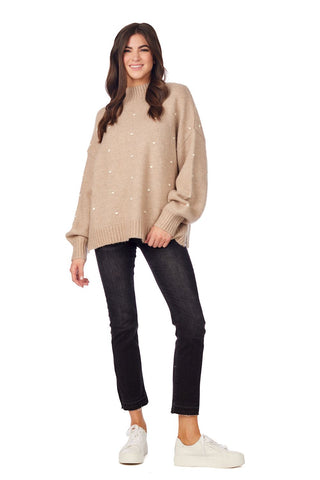 Tan oversized sweater with knit pom poms