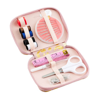Pink sewing kit with scissors, threads, needles, and other tools