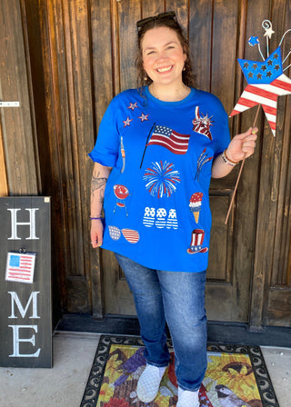 Merica Top	Merica top – patriotic blue tee with flag graphic and red sequin sleeves