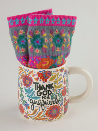 Mug with floral design and socks with colorful patterns