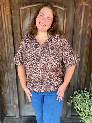 Leopard print blouse with puffed sleeves and scalloped hem