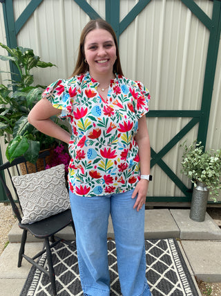 Iris Floral Blouse	Iris floral blouse – multicolor women’s top with flutter sleeves and bright bold print