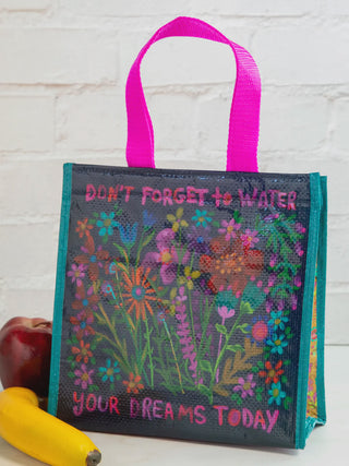 Reusable shopping bag with floral design and motivational text