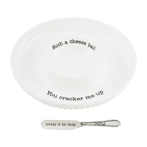 A white ceramic cheese ball dish with a silver-plate spreader, featuring text on the dish that reads 'You cracker me up' and 'Such a cheese ball'. The spreader has the text 'Spread it on thick'.