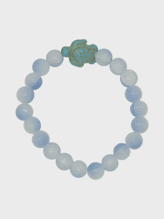 Beaded bracelet with a green turtle charm on a white background