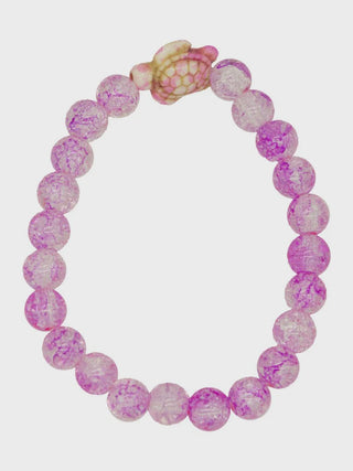 Pink and purple beaded bracelet with a small pink charm on a white background