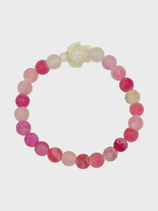 Bracelet with pink and white beads on a white background