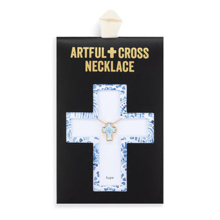 Artful cross necklace displayed on a decorative stand with 'Artful Cross Necklace' text above.