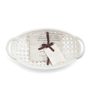 White woven basket with a piece of paper and a tag on a white background