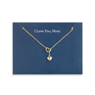A heart necklace with a locket hanging from the heart on a navy card that says 'I love you, mom'