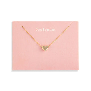 Gold heart necklace on a pink card with 'Just Because' 