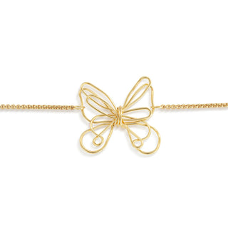 Gold butterfly-shaped pendant on a chain bracelet against a white background
