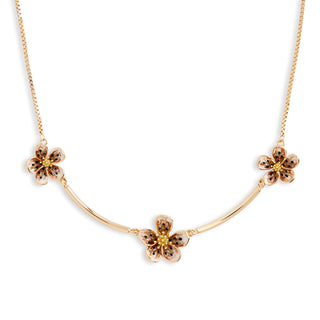 Gold necklace with floral pendants on a white background