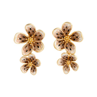 Pair of floral earrings with gold accents on a white background