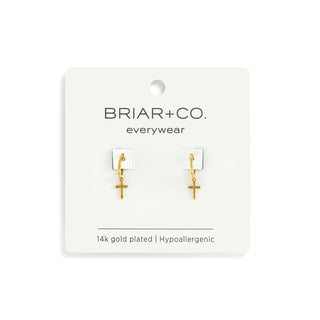Gold cross earrings on a Briar+Co. card with hypoallergenic information.