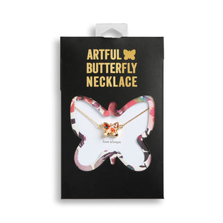 Butterfly necklace in a branded box with 'Artful Butterfly Necklace' text.