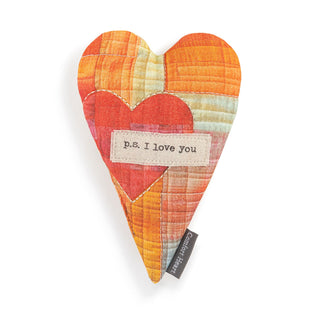 Heart-shaped fabric pillow with 'p.s. I love you' label 