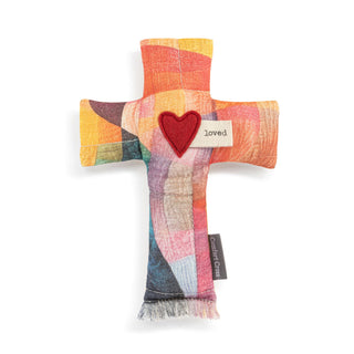 Colorful cross-shaped plush toy with a heart and 'loved' tag 