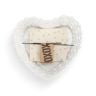 Heart-shaped basket with a folded card and pen on a white background