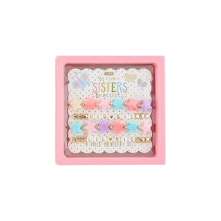 Set of colorful bracelets with 'Big Sisters Little Sisters' text in a pink box on a white background