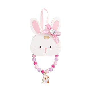 White rabbit-shaped toy bracelet
 with pink bow and beads on a white background