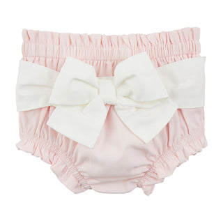 A light pink diaper cover featuring an elastic, ruffled waistband and leg openings, adorned with a large, decorative white fabric bow across the back.