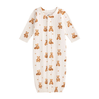 An off-white infant sleeper gown featuring a repeating pattern of small, classic brown teddy bears and tiny paw prints.