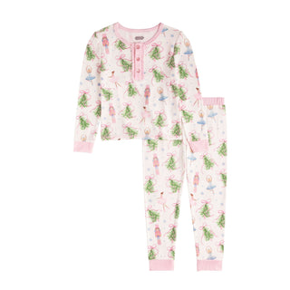 A two-piece pajama set featuring a Nutcracker-themed pattern with ballerinas, nutcrackers, and pine branches tied with pink bows.