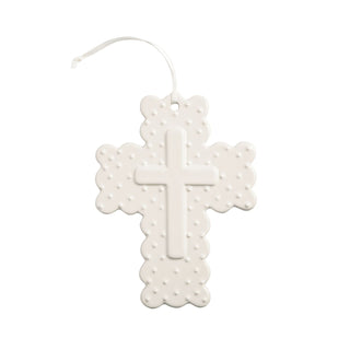 White cross-shaped air freshener with perforated design on a white background