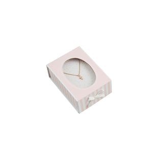 Pink jewelry box with a gold necklace inside on a white background
