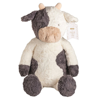 A soft, black-and-white spotted cow plush toy sitting down, featuring tiny horns, a tan snout, and a tag that reads "meet Maisie the cow."