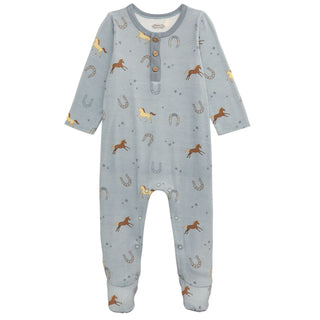 Children's onesie with horse and horseshoe pattern on a light blue background