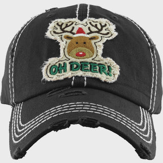 A distressed black baseball cap with white contrast stitching, featuring a large embroidered patch of a reindeer with antlers and the text 'OH DEER!' in green and red.