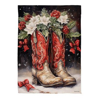 Decorative flag with red cowboy boots, white flowers, and red ribbons on a black background