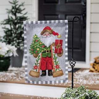 Decorative garden flag with a festive design of Santa Claus holding a tree and gift.