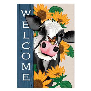 Decorative sign with a cow and sunflowers featuring the word 'Welcome'.