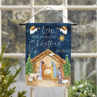 Decorative Christmas flag with nativity scene and text 'Love was born on Christmas morn' 