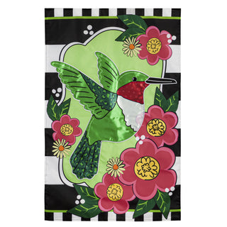 Decorative house flag with a green hummingbird and pink flowers on a black and white striped background