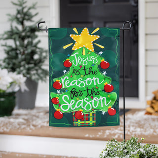 Decorative garden flag with Christmas tree design and text 'Jesus is the Reason for the Season'