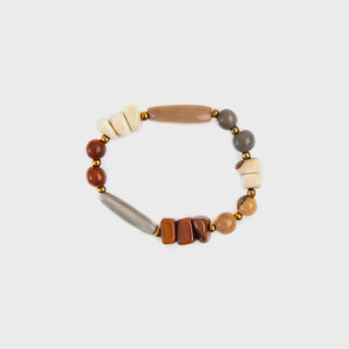 Beaded bracelet with wooden and stone-like beads on a light gray background
