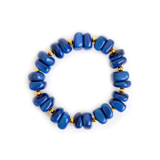 Blue beaded bracelet with gold accents on a white background