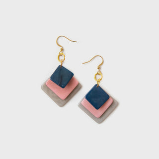 Color-blocked square earrings on a light gray background