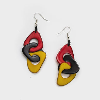 Colorful earrings with red, yellow, and black geometric shapes on a white background