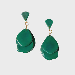Pair of green teardrop earrings on a light gray background