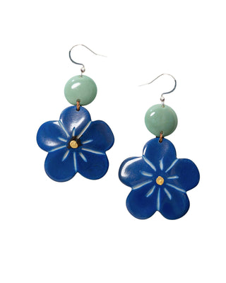 Blue flower-shaped earrings with green beads on a white background