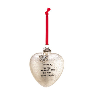Heart-shaped ornament with text 'Teacher, you're number one on the nice list.' and a red ribbon