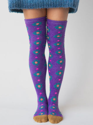 Purple floral knee-high socks worn by a person 